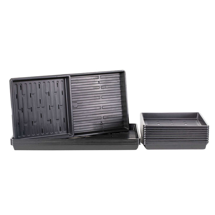 Stacked black microgreen trays; perforated drainage trays and solid nursery flats for seed starting.