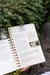 Gardening guide open to "Organize Old Seeds," showing seed storage tips, a seed organizer, and green herbs.