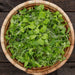 Vibrant fresh microgreens mix in a natural woven basket on a dark wood background. Organic salad greens.
