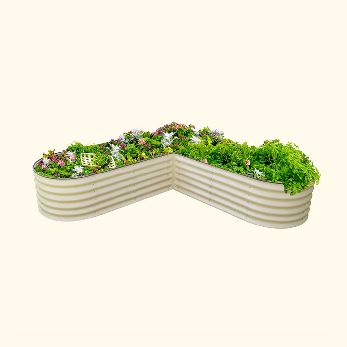 Angled tan corrugated steel raised garden bed with flowers, herbs, and lush green plants. Ideal for backyard gardening.