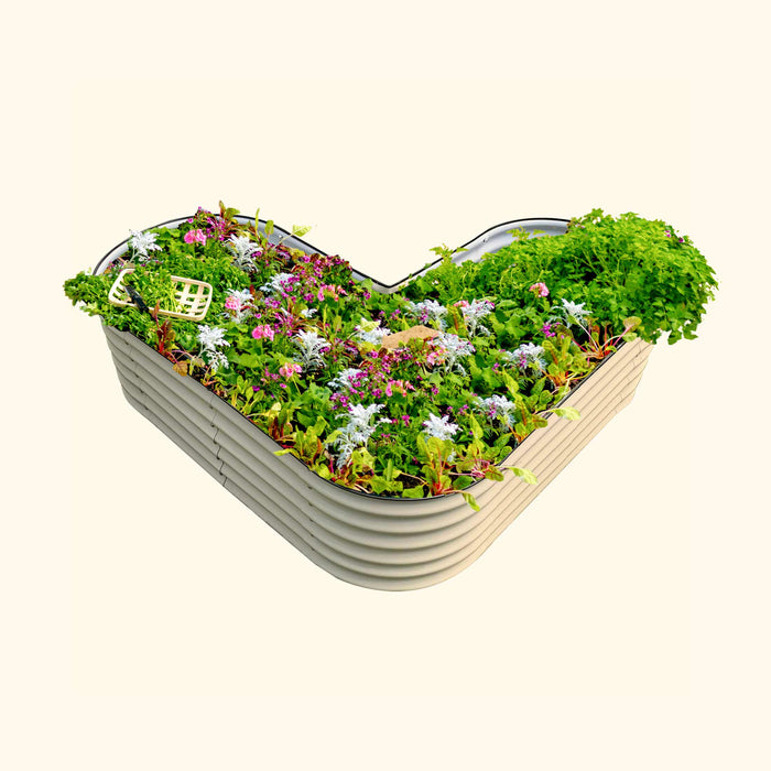 L-shaped beige metal raised garden bed with vibrant flowers, green herbs, and vegetables. Small garden basket included.