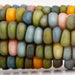 Vibrant Glass Gem corn kernels, multi-colored heirloom corn in green, blue, pink, orange, and yellow.