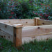 Square wooden raised garden bed on green grass, ready for backyard vegetable planting. Ideal DIY gardening solution.