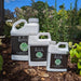 Three 9-1-1 Reviver Emergency Fertilizer bottles on garden mulch. Professional grade, water soluble plant nutrients for vibrant plants.