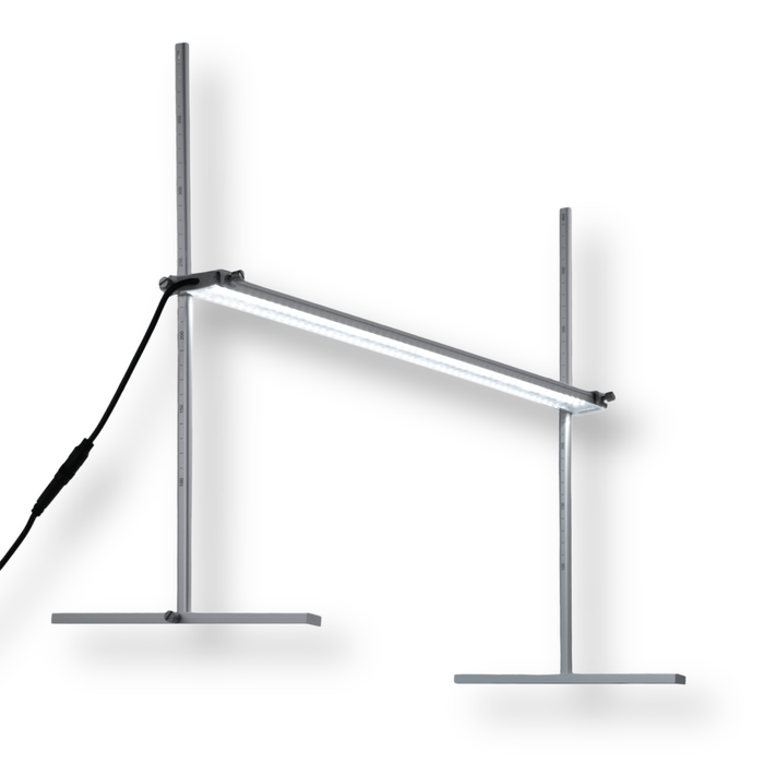 Adjustable LED light bar on two height-marked stands. Bright white light, ideal for grow lights or lab experiments.