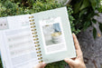 Gardening planner open to seed health test and 'Month Two Tend' pages. Features sprout germination guide and watering seedlings.
