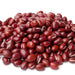 Pile of vibrant red adzuki beans on a white background. Healthy dried legumes for cooking and baking.