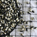Black and white Yin Yang beans in a black bowl, spilled onto a white checkered tablecloth. Dried legumes for cooking.