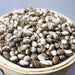 Bowl of dried cranberry beans, brown and white speckled legumes.
