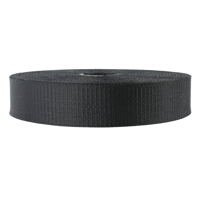 Roll of black heavy-duty webbing, woven polypropylene strap for bags, outdoor gear, tie-downs.