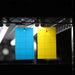 Blue and yellow sticky insect traps with grid lines, hanging under grow lights for pest control and monitoring.