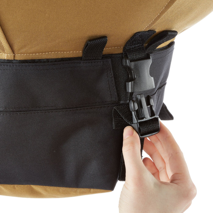 Hand adjusting black plastic buckle on a rugged tan & black backpack. Secure strap for outdoor gear.