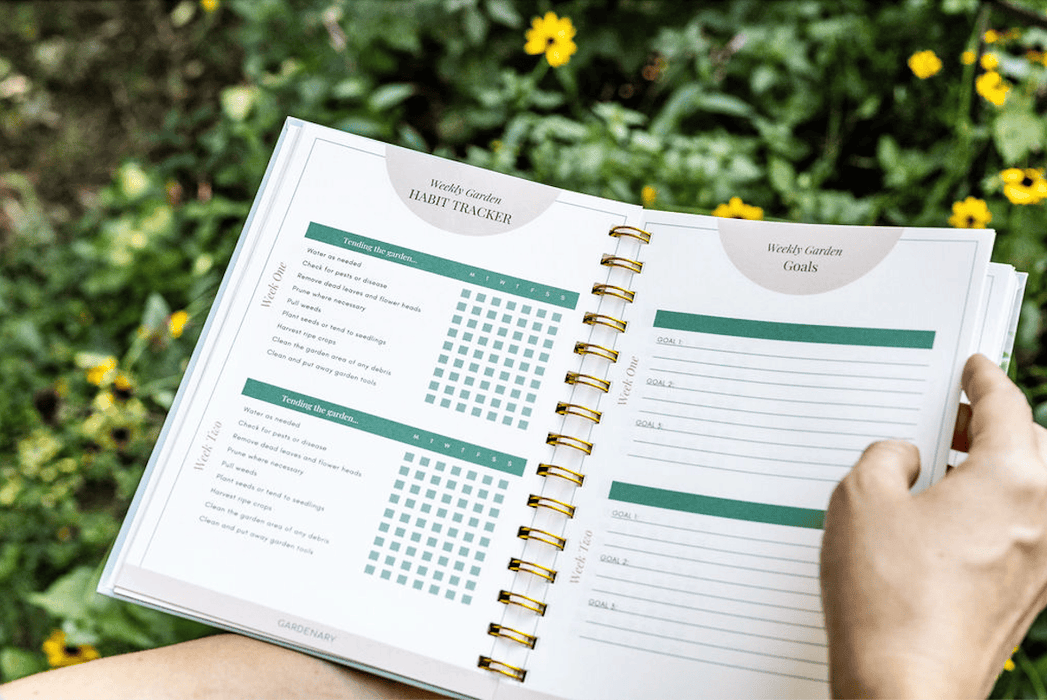 Open "Weekly Garden Habit Tracker" and "Goals" planner in a garden. Features tasks like watering, weeding, and plant care.