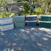 Colorful corrugated metal raised garden beds in beige, olive, dark blue, dark green. Durable planters for backyard gardening.