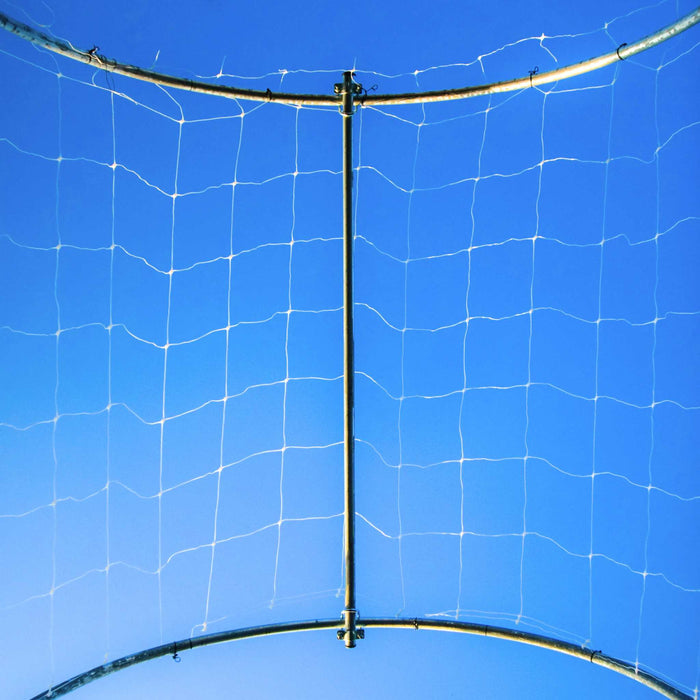White grid netting on a metal support structure, set against a bright blue sky. Perfect for sports, garden, or safety barriers.