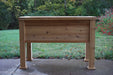 Elevated wooden planter box for outdoor gardening. Sturdy natural wood raised garden bed on a patio.