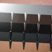 Modern metal roofing panels in silver, brown, and black with textured finish and interlocking design.