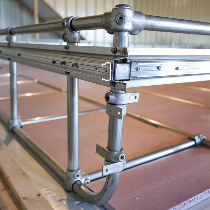 Modular metal frame using Kee Klamp pipe fittings and aluminum T-slot extrusions. Custom industrial structure or workbench.