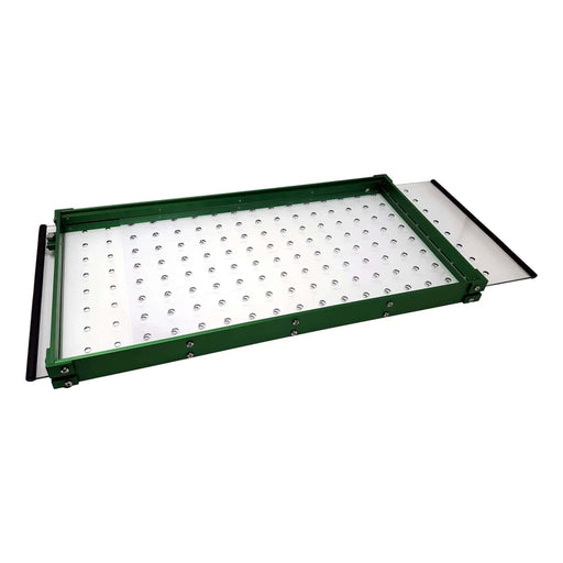 Green-framed rectangular LED light panel with clear studded surface and a translucent slide-out tray.