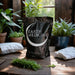 Earth Medicine organic microbial fertilizer bag (5lb) with houseplants & fresh greens on a wooden table. Enhances soil fertility.