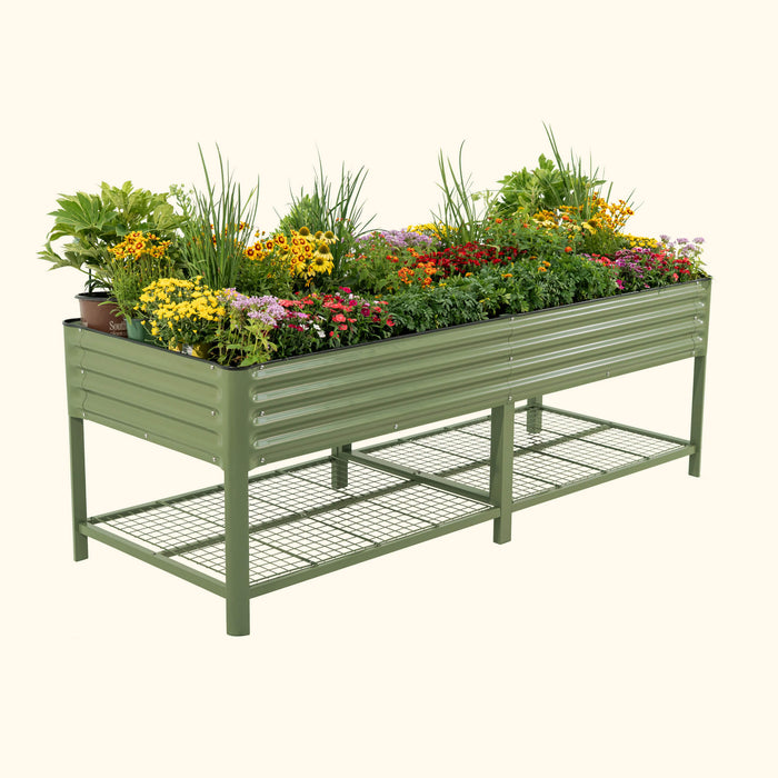 Olive green corrugated metal raised garden bed filled with colorful flowers and a lower wire mesh storage shelf.