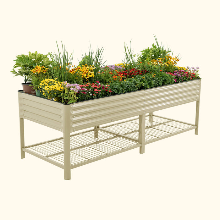 Beige metal raised garden bed with colorful blooming flowers. Elevated planter box design with a useful wire mesh storage shelf.
