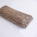 Dark granular mushroom substrate block with perlite for cultivation.