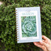 Hand holds "Cold SEASON" Gardenary planner with a vibrant savoy cabbage cover, perfect for winter garden planning.