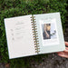Gardenary spiral gardening planner open to "Table of Contents" (planting, tending, harvesting) & "Month One Plant" guide on foliage.