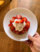 Golden pancake topped with fresh sliced strawberries and whipped cream. Delicious breakfast dessert.