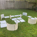 DIY raised garden bed kit: corrugated metal panels in white & beige laid on grass, ready for assembly.