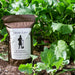 Sassy Lass Beneficial Bacteria Booster & Root Enhancer on garden soil, surrounded by lush green plants for healthy growth.