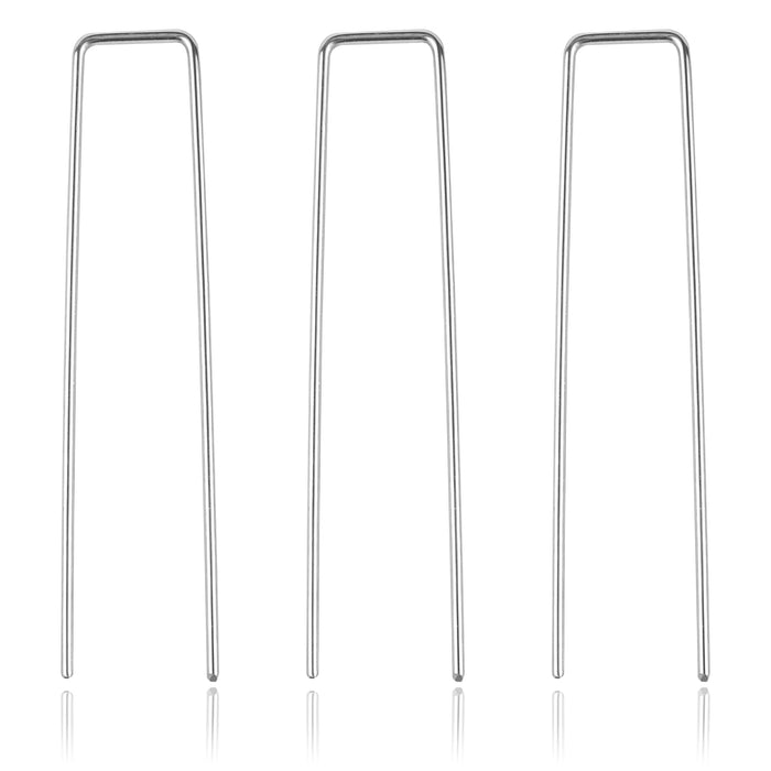 Three silver U-shaped metal landscape staples for securing sod, garden fabric, and irrigation hoses.