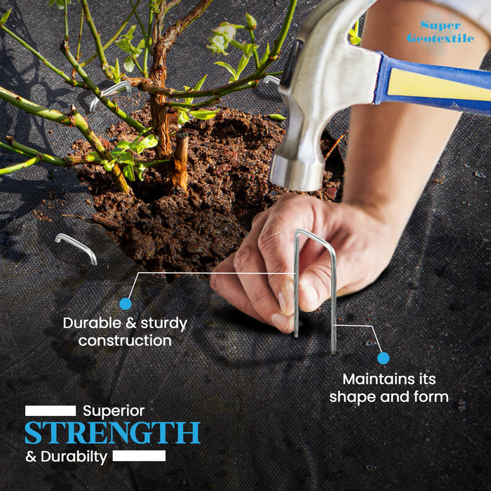 Hand installing strong metal garden stakes into black weed barrier fabric around a plant. Durable geotextile for weed control.