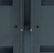 Dark grey resin outdoor storage cabinet panel detail with metal bolt, nut, and screws for assembly.