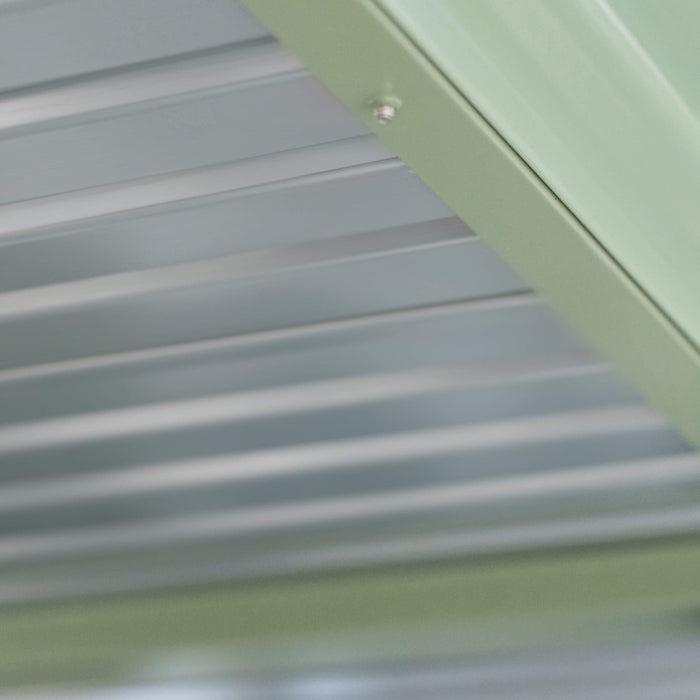 Light grey corrugated metal panels with a light green trim and screw. Durable roofing, siding, or building material.