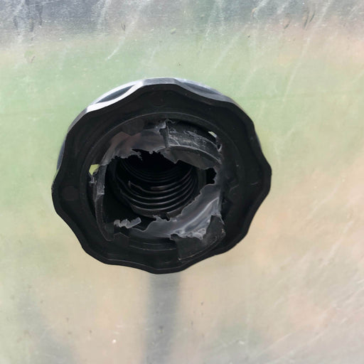 Damaged black threaded bulkhead fitting, torn internal seal. Plastic water tank part, repair or replacement needed.