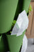 Green vertical garden planter with young plants and a translucent, geometric GreenStalk plant marker.
