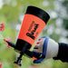 Orange Venus Super 360 garden sprayer misting pink flowers. Gloved hand operates 1.0L plant watering tool.