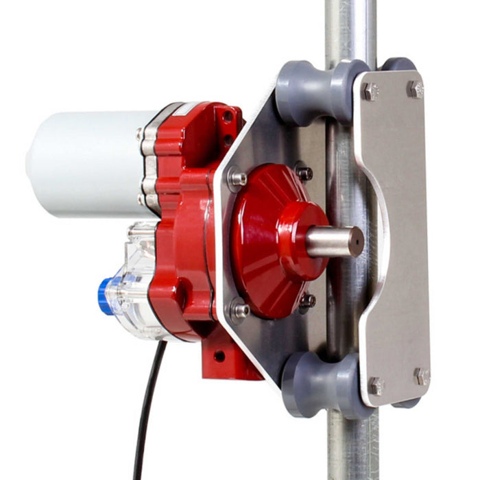 White motor and red industrial fluid pump system mounted on a metal pole with gray rollers.