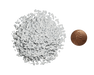 White granular material pile with a US penny for scale, showing small particle size.