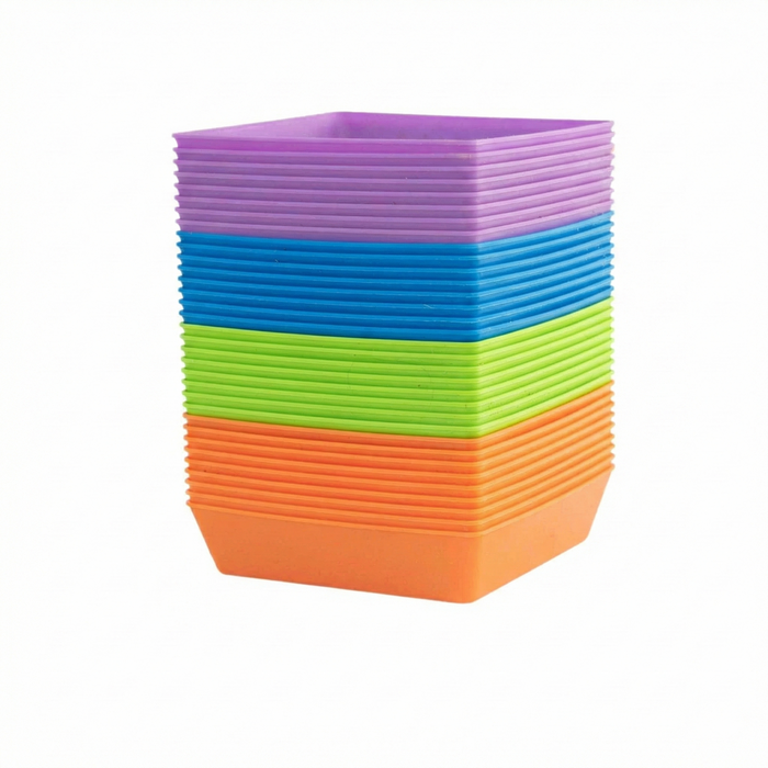 Stack of colorful plastic square plant pots in purple, blue, green, and orange for seed starting or nursery.