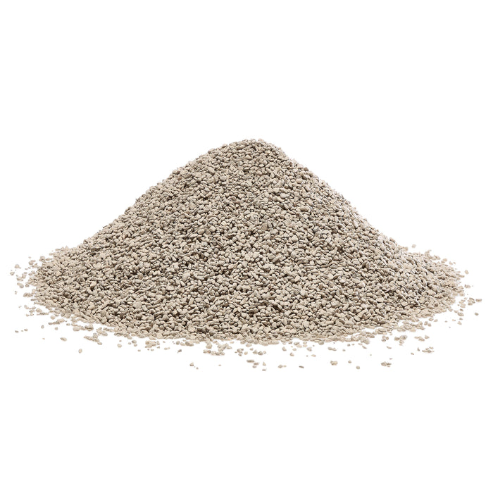 Light grey granular material mound. Small absorbent pellets for cat litter, drainage, or industrial use.