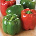 Fresh red and green bell peppers on a wooden board. Vibrant, healthy vegetables for cooking and salads.