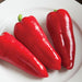 Three fresh red sweet peppers on a white plate. Ripe bell peppers for healthy cooking and salads.