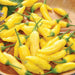 Bright yellow hot chili peppers with green stems. Fresh, vibrant, and perfect for adding spice to dishes.