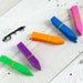 Bundles of colorful plastic garden plant markers (blue, pink, orange, purple, green) on rustic white wood.