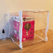 Pink Oyster Mushroom Growing Kit Depot in clear humidity tent with spray bottle for easy home cultivation.