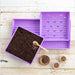 Purple microgreen trays with soil, seeds in bowls, and a spoon. Ideal for indoor seed starting and home gardening.
