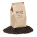 Urban Worm Company organic worm castings bag on a pile of nutrient-rich soil amendment for plants.